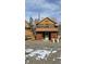 Charming two-story home with a rustic exterior and a mix of log and wood siding at 605 Argentine St, Georgetown, CO 80444