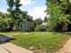Spacious backyard with green lawn, shed and plenty of shade trees at 4125 Pierce St, Wheat Ridge, CO 80033