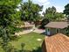 Aerial view of a fenced backyard with a detached garage and storage shed at 4125 Pierce St, Wheat Ridge, CO 80033