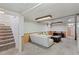 Cozy basement living space with carpet, sofa, coffee table, and stairway access at 4125 Pierce St, Wheat Ridge, CO 80033
