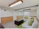 Basement rec room featuring a white couch, green pillows, carpeted flooring, and light fixtures at 4125 Pierce St, Wheat Ridge, CO 80033