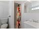 Bathroom featuring a toilet, sink with mirror, and shower with a vibrant shower curtain at 4125 Pierce St, Wheat Ridge, CO 80033