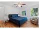 Cozy bedroom with hardwood floors, a comfortable bed, and ample natural light at 4125 Pierce St, Wheat Ridge, CO 80033