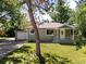 Charming home with a covered front porch and well-manicured lawn with mature tree at 4125 Pierce St, Wheat Ridge, CO 80033
