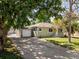 Charming home with a well-maintained lawn and long driveway leading to a detached garage at 4125 Pierce St, Wheat Ridge, CO 80033