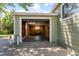 Attached garage with open overhead door and workbench inside at 4125 Pierce St, Wheat Ridge, CO 80033