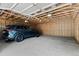 Spacious garage interior showing a car and exposed ceiling beams at 4125 Pierce St, Wheat Ridge, CO 80033