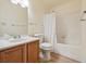Bright bathroom featuring a single vanity, toilet, and shower/tub combo with white tiling at 3847 Mossy Rock Dr # 104, Highlands Ranch, CO 80126