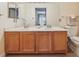Bathroom features a double sink vanity with wood cabinets and ample counter space at 3847 Mossy Rock Dr # 104, Highlands Ranch, CO 80126