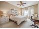 Cozy bedroom features soft neutral decor, ceiling fan, and natural lighting at 3847 Mossy Rock Dr # 104, Highlands Ranch, CO 80126