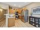 Bright kitchen featuring stainless steel appliances and light wood cabinets with neutral decor at 3847 Mossy Rock Dr # 104, Highlands Ranch, CO 80126