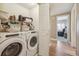 Convenient laundry area equipped with modern washer and dryer, complemented by ample shelving for storage at 3847 Mossy Rock Dr # 104, Highlands Ranch, CO 80126