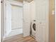 Well-organized laundry area featuring a washing machine and built-in shelving for storage at 3847 Mossy Rock Dr # 104, Highlands Ranch, CO 80126