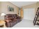 Cozy living room showcasing a plush, reclining love seat and neutral decor, creating a relaxing atmosphere at 3847 Mossy Rock Dr # 104, Highlands Ranch, CO 80126