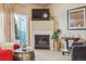 Close-up on a fireplace with a TV in a neutral living room with new wood-look floors and neutral walls at 3847 Mossy Rock Dr # 104, Highlands Ranch, CO 80126