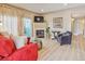 Cozy living room featuring a fireplace, modern furniture, and a bright, airy feel with wood-look floors at 3847 Mossy Rock Dr # 104, Highlands Ranch, CO 80126