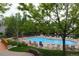 Outdoor pool with lounge chairs surrounded by trees and greenery at this community at 3847 Mossy Rock Dr # 104, Highlands Ranch, CO 80126