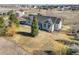 Aerial view showcases this charming single-story home with a landscaped yard and a serene setting at 56450 E 40Th Ave, Strasburg, CO 80136