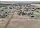 Sprawling countryside showcasing residences in a rural community with vast open fields and clear blue skies in the background at 56450 E 40Th Ave, Strasburg, CO 80136