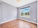 Cozy bedroom with wood floors and a large window offering natural light and neighborhood views at 56450 E 40Th Ave, Strasburg, CO 80136