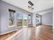 An open dining room features laminate flooring, large windows and an overhead light fixture at 56450 E 40Th Ave, Strasburg, CO 80136