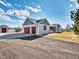 Spacious home features a convenient two-car garage and a gravel driveway at 56450 E 40Th Ave, Strasburg, CO 80136