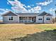 Attractive single-story home featuring a welcoming front porch and well-maintained lawn at 56450 E 40Th Ave, Strasburg, CO 80136