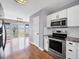 Bright kitchen featuring a stainless steel oven and appliances with a view to the dining room at 56450 E 40Th Ave, Strasburg, CO 80136