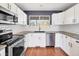 Updated kitchen features stainless appliances, granite countertops, and bright white cabinetry at 56450 E 40Th Ave, Strasburg, CO 80136