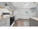 Modern kitchen with white appliances, granite countertops, and ample cabinet space at 4046 S Bannock St, Englewood, CO 80110