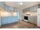 Spacious kitchen features grey cabinetry, stainless steel appliances, and wood-look flooring at 4046 S Bannock St, Englewood, CO 80110