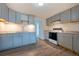 Spacious kitchen features grey cabinetry, stainless steel appliances, and wood-look flooring at 4046 S Bannock St, Englewood, CO 80110
