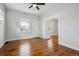 Cozy living room features hardwood floors, a ceiling fan, and an entry door at 4046 S Bannock St, Englewood, CO 80110