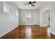 Cozy living room features hardwood floors, a ceiling fan, and an entry door at 4046 S Bannock St, Englewood, CO 80110