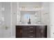 Bathroom featuring double sinks, granite countertops, dark cabinets, and large walk-in shower at 6700 Clay St, Denver, CO 80221