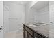 Bathroom with granite counters, dual faucets, shower-tub, and ample cabinet space at 6700 Clay St, Denver, CO 80221