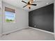 Bright bedroom featuring a ceiling fan and a large window with natural light at 6700 Clay St, Denver, CO 80221