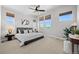 Bright bedroom features large windows, modern ceiling fan, and minimalist decor at 6700 Clay St, Denver, CO 80221