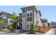 Contemporary gray home featuring stone accents, a small front yard, and modern architectural details at 6700 Clay St, Denver, CO 80221