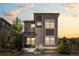 Modern two-story home with stone accents, complemented by professionally landscaped front yard at 6700 Clay St, Denver, CO 80221