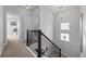 Hallway features dark railings, carpeted floors, and natural lighting at 6700 Clay St, Denver, CO 80221