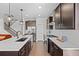 Modern kitchen with white countertops, dark cabinets, stainless steel appliances, and an open layout at 6700 Clay St, Denver, CO 80221