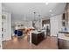 Open-concept kitchen and living area with hardwood floors, stylish furniture, and ample natural light at 6700 Clay St, Denver, CO 80221