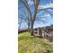 Backyard with chicken coops and shaded trees provide a rustic and unique outdoor experience at 7181 Beech St, Arvada, CO 80004