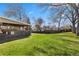 Large backyard has covered patio, big trees, and privacy fence at 7181 Beech St, Arvada, CO 80004