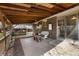 Spacious covered patio area with wood plank detail provides an outdoor dining and lounge area at 7181 Beech St, Arvada, CO 80004