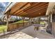 Covered patio with wood features and space for entertaining and enjoying the backyard at 7181 Beech St, Arvada, CO 80004