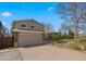 Two-story home featuring a spacious driveway and mature shade tree at 7181 Beech St, Arvada, CO 80004