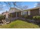 Charming brick home featuring a well-maintained lawn and mature landscaping at 7181 Beech St, Arvada, CO 80004