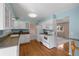 Bright kitchen boasts white cabinets, modern appliances, and hardwood floors at 7181 Beech St, Arvada, CO 80004